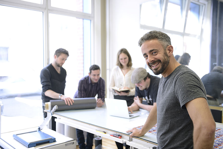 Team members at a table reviewing actual work together
